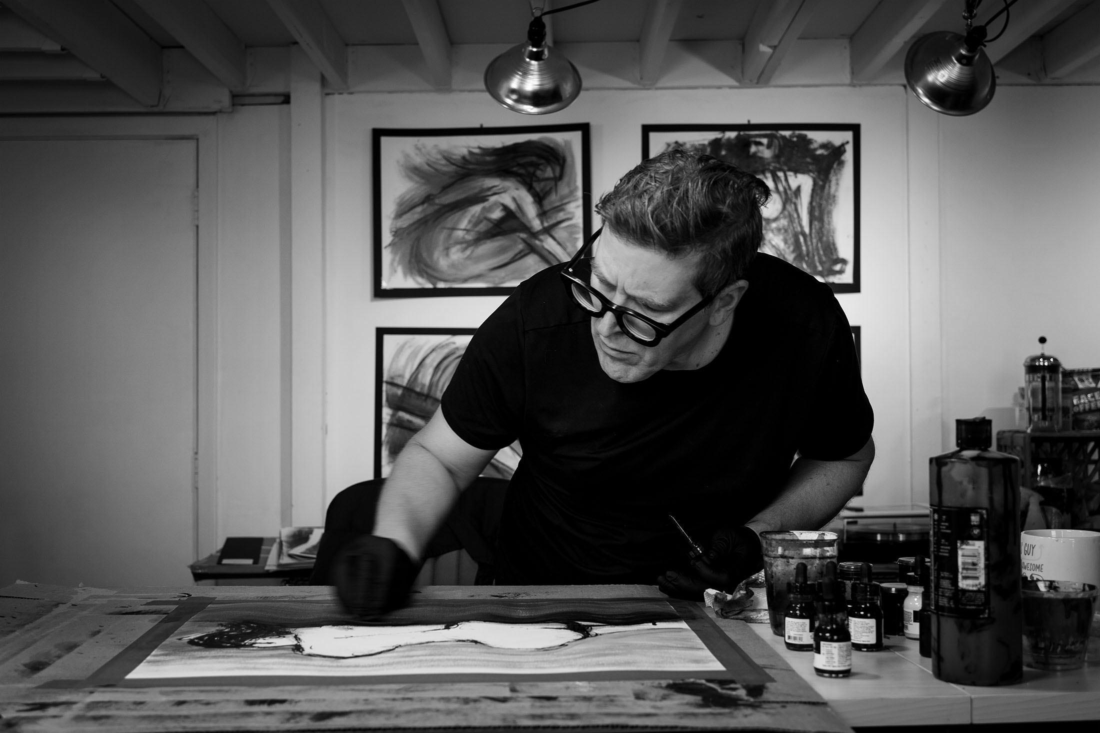 photo of Michael Tangen creating ink-based art